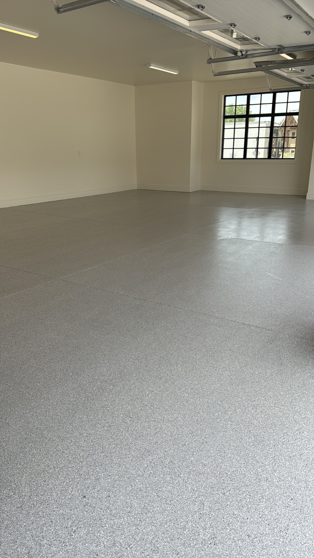 Clean grey flake floor in a bright, empty room